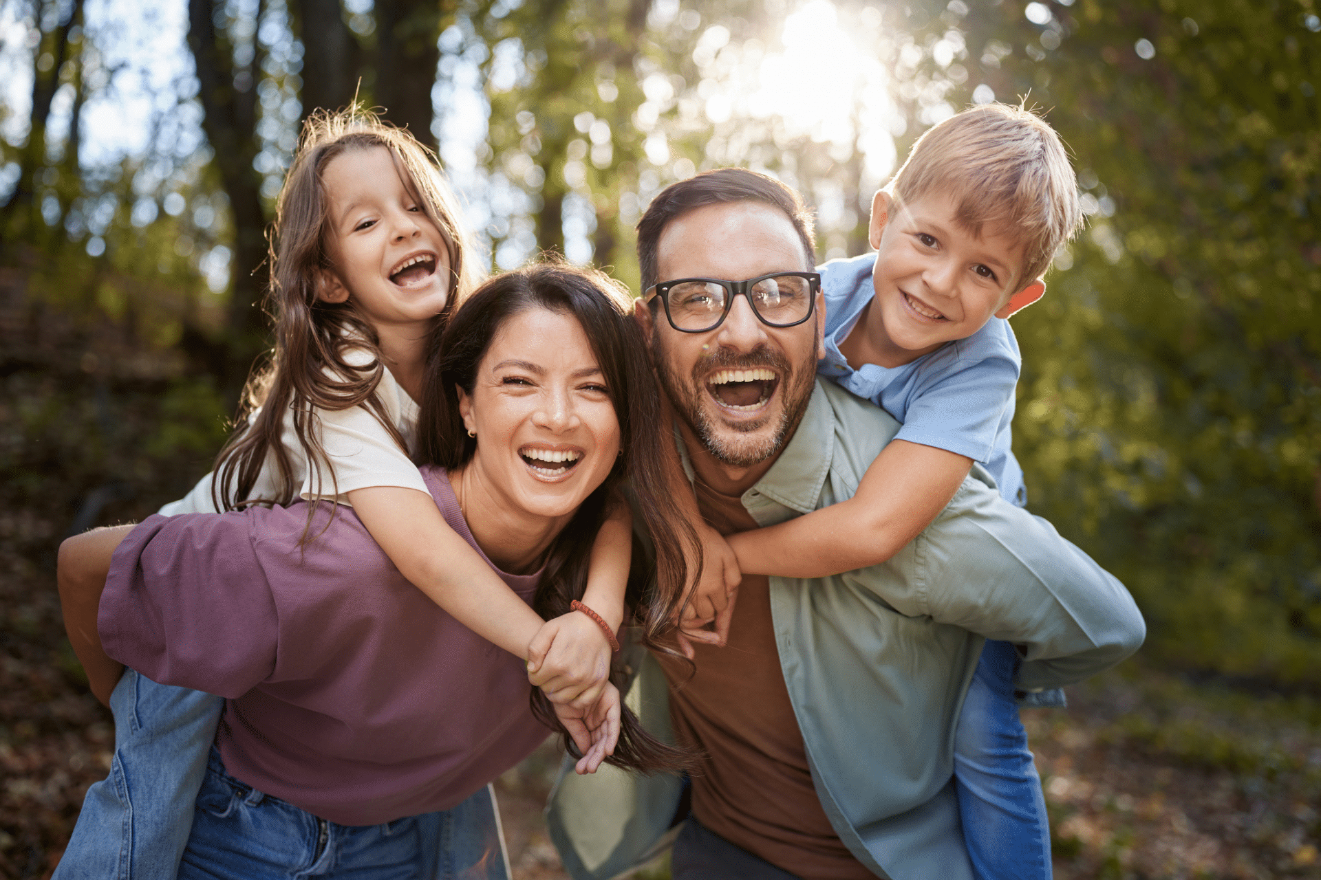 Family smiling together while considering dental care in Mountain Home, AR